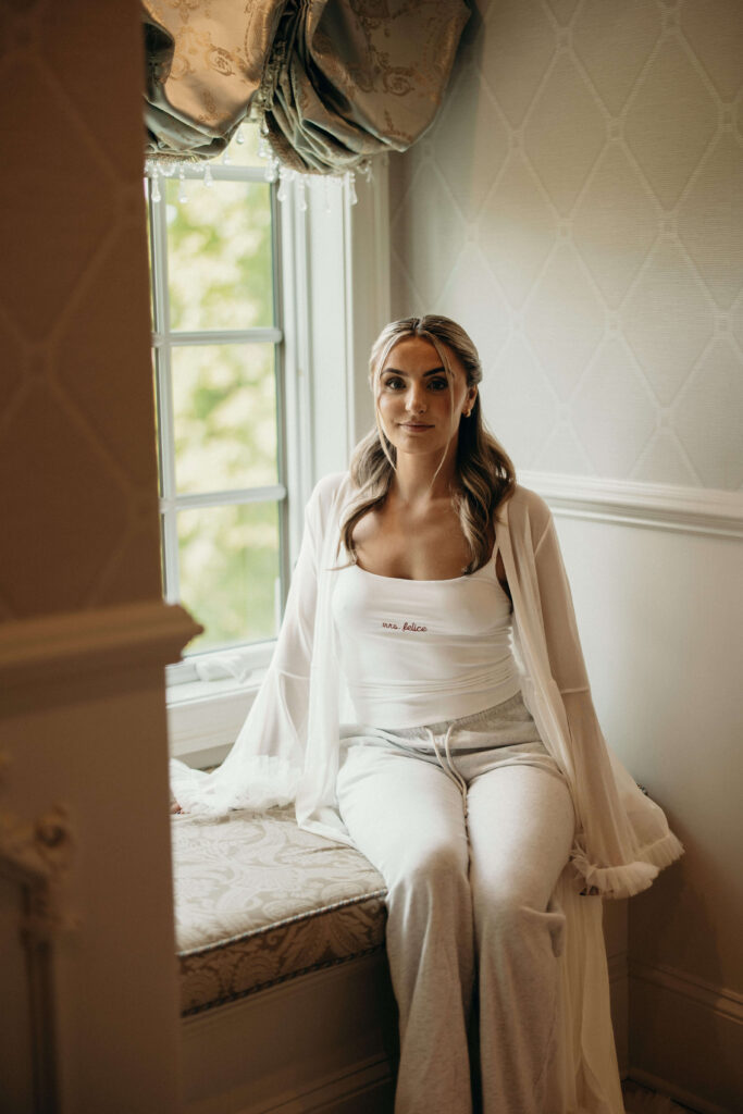 Bride Shay relaxing in bridal loungewear while getting ready at The Ashford Estate