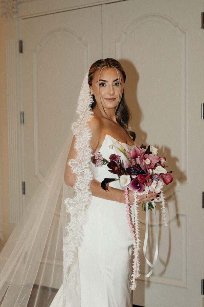 Bride Shay holding her wedding bouquet in her gown before the ceremony at The Ashford Estate