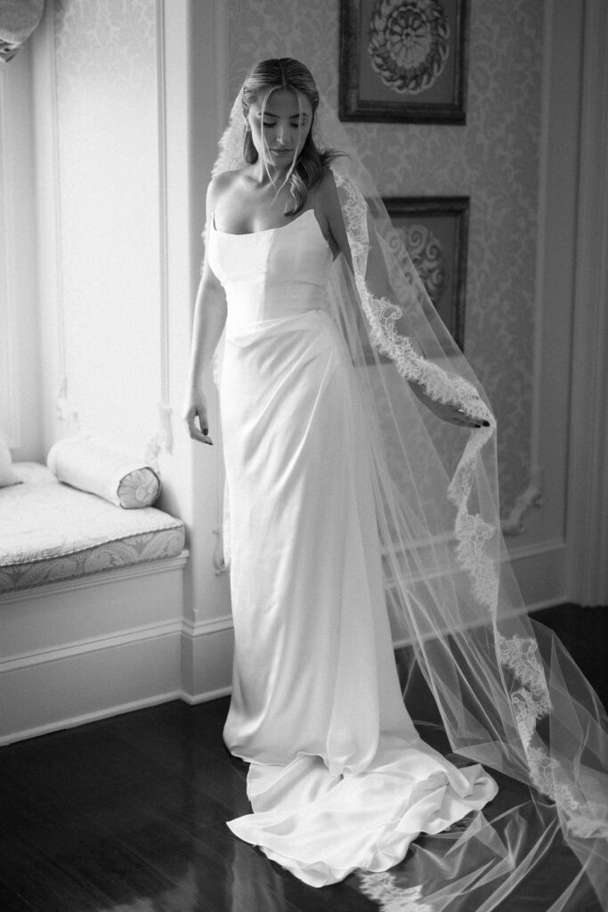 Black and white portrait of bride Shay in her wedding dress and lace-edged veil at The Ashford Estate