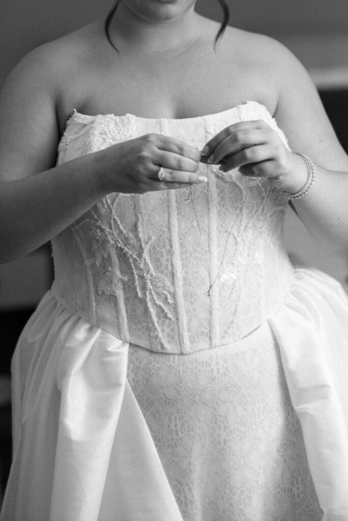Bride adjusting her wedding dress at Le Bilboquet, New York City
