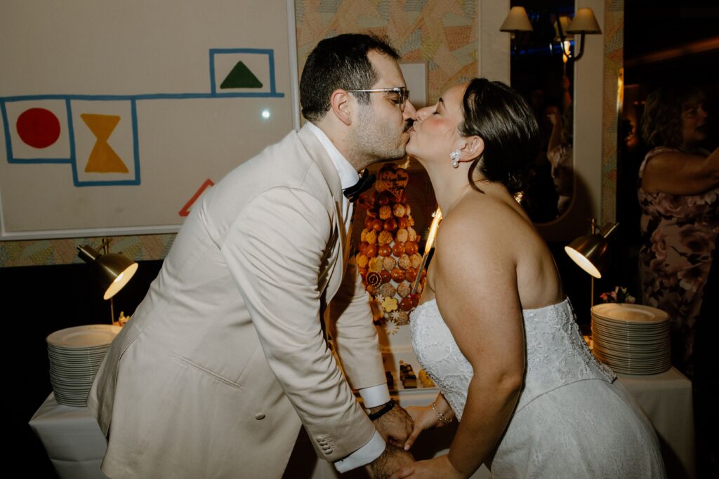 Newlyweds sharing a kiss during their wedding reception at Le Bilboquet, New York City | New Jersey wedding photographer