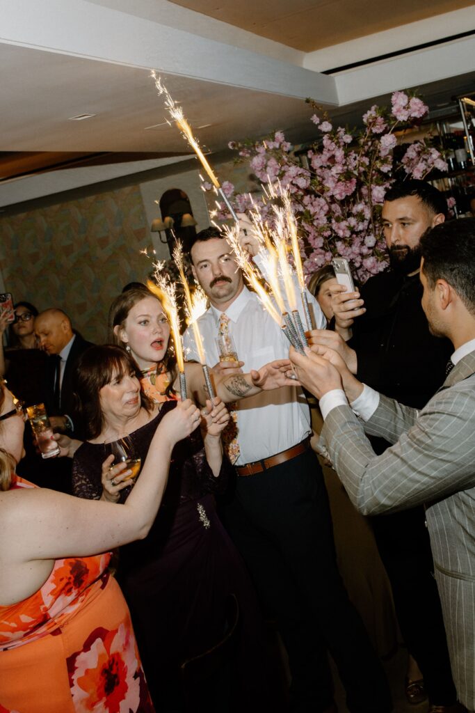 Wedding guests celebrating with sparklers at Le Bilboquet, New York City | New Jersey wedding photographer