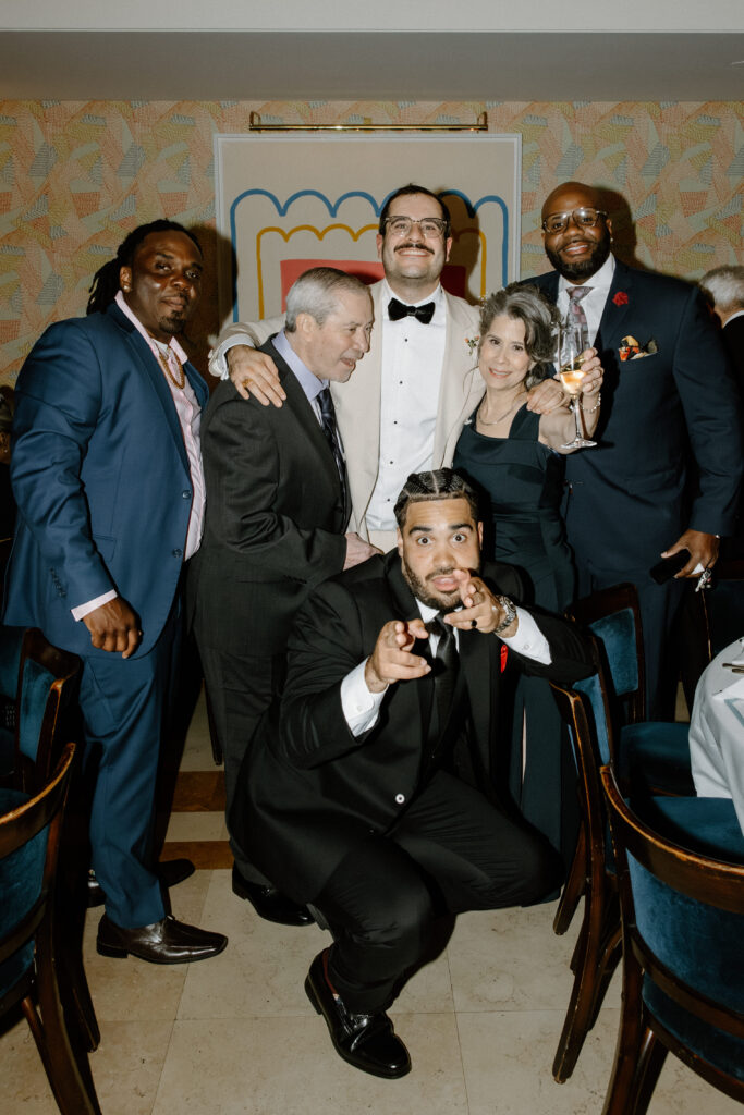Newlyweds posing with friends at Le Bilboquet