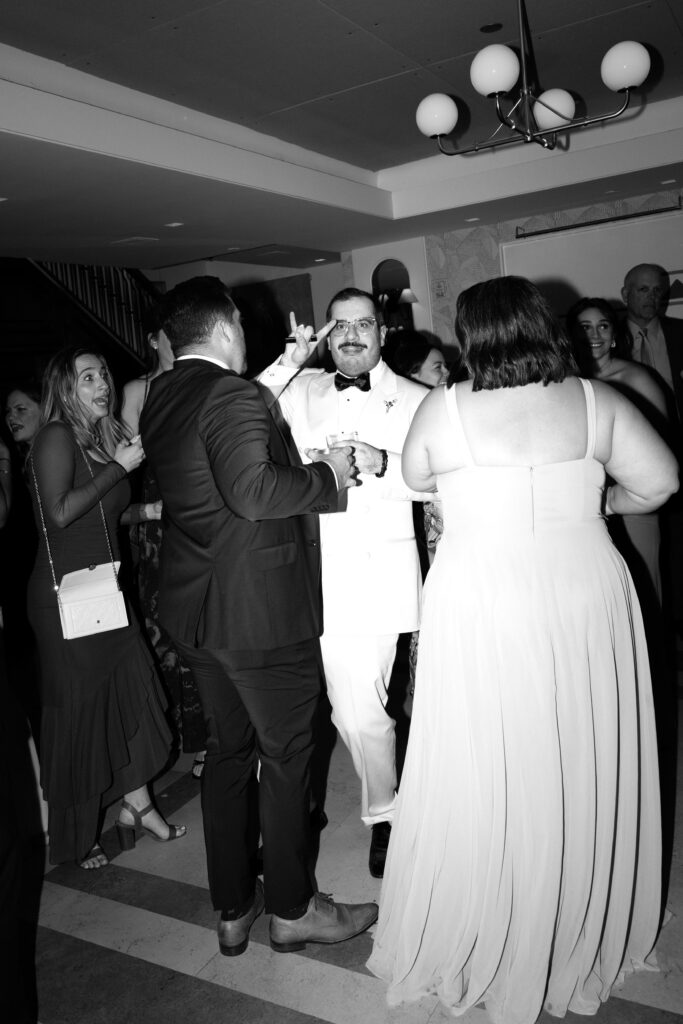 Newlyweds dancing with guests at Le Bilboquet
