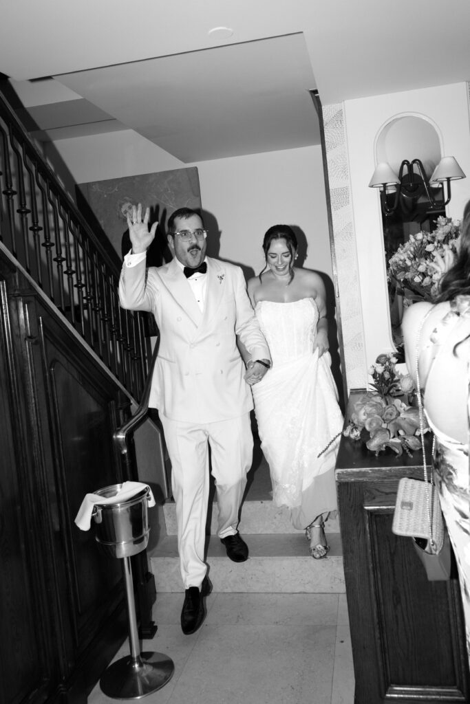Newlyweds walking down the stairs at Le Bilboquet