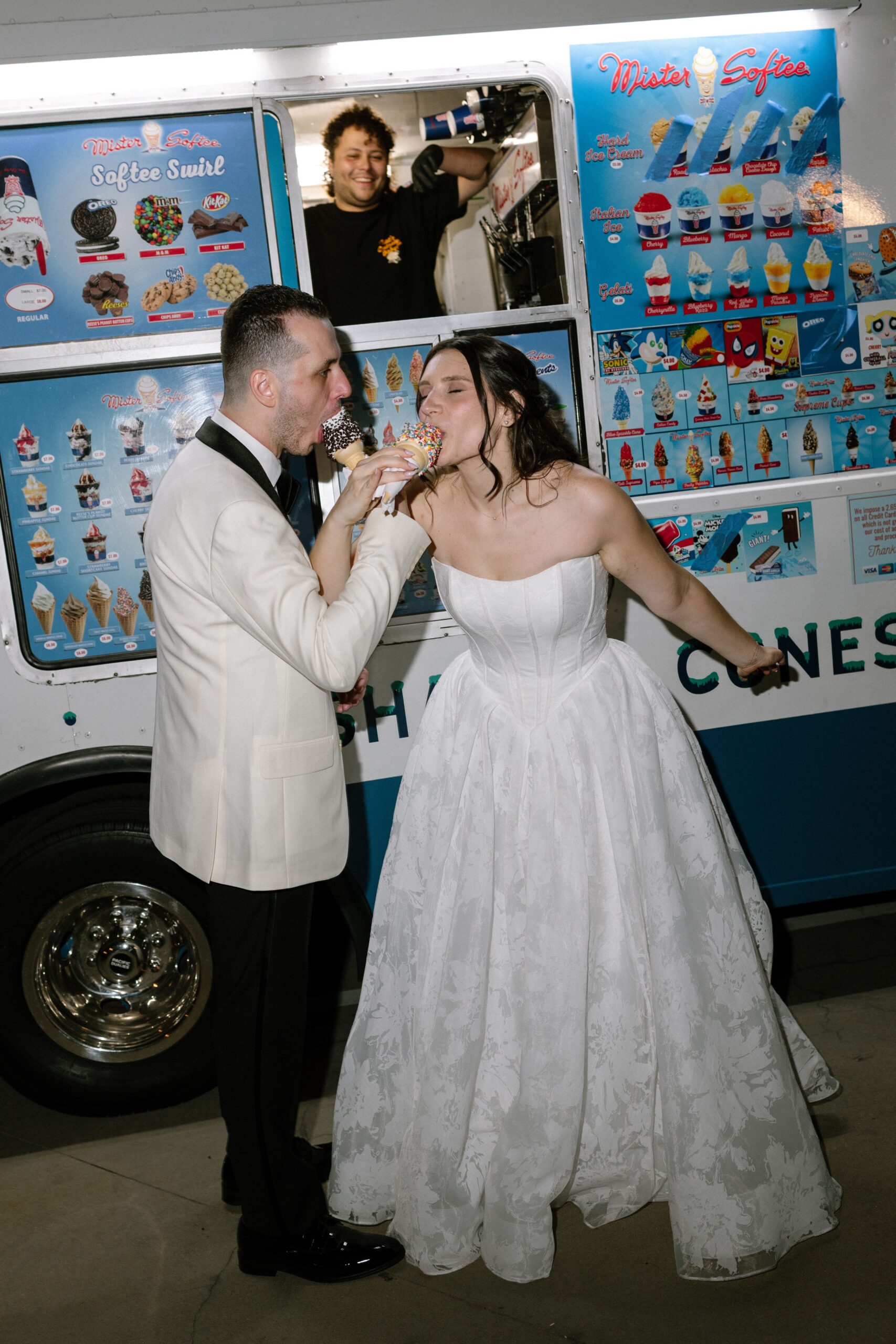 Newlyweds enjoying ice cream cones outside an ice cream truck at Battell