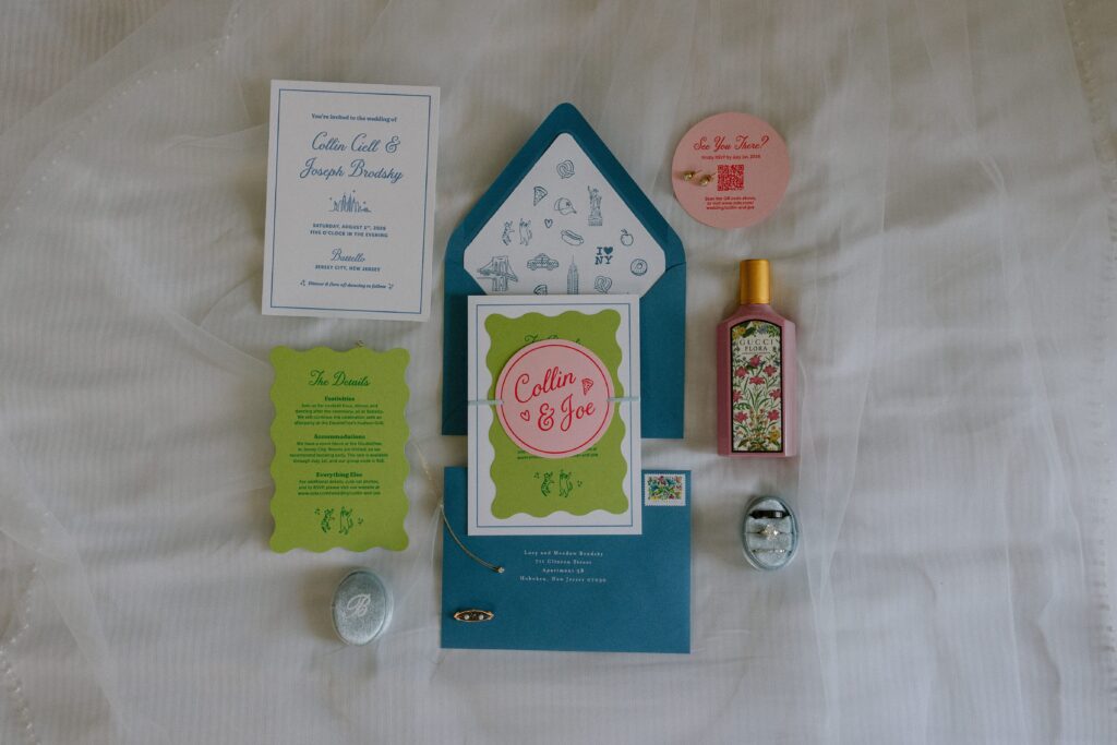 Flat lay of wedding stationery, perfume, and rings for a Battello wedding