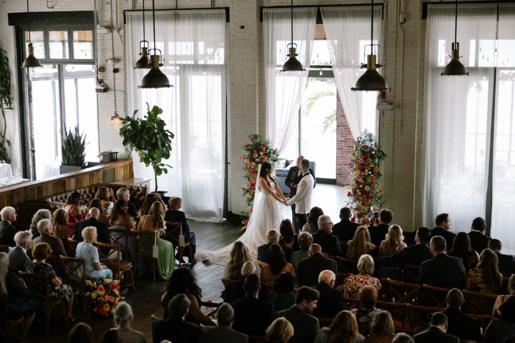 Wide view of a wedding ceremony with guests at Battello