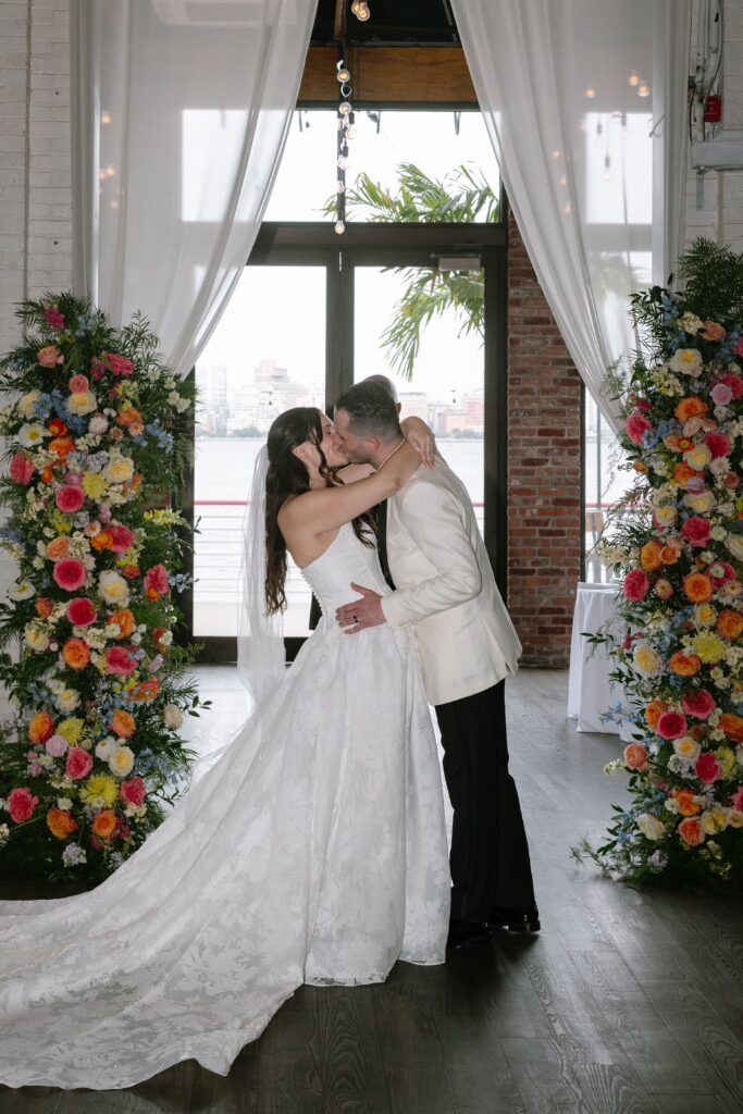 Bride and groom kissing at the altar at Battello