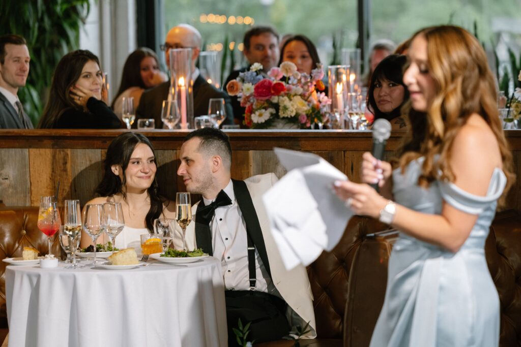 Bridesmaid delivering a speech during the wedding reception dinner at Battello
